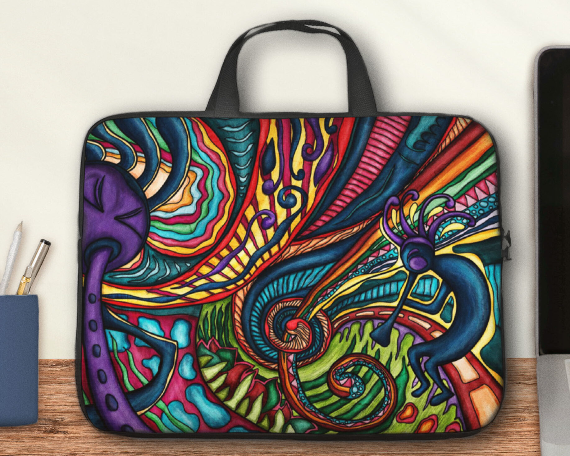Laptop bag with handles, printed with a colorful Kokopelli art.